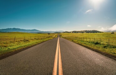 Spectacular view of a long road in Solvang, California, with the rolling hills in the background