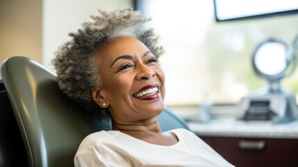 Wall Mural - Portrait of a happy dark-skinned adult woman in a dental office. African American woman undergoes a consultation with a dentist in a specialized clinic. Dental health concept.