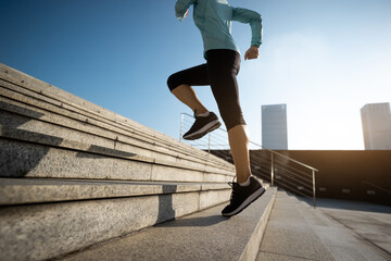 Canvas Print - Fitness sports woman running up stairs in city