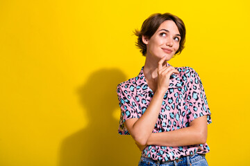 Sticker - Photo of gorgeous creative positive person hand touch chin look interested empty space isolated on yellow color background