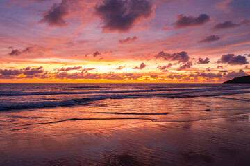 aerial view Wave after wave swept towards the shore at sunset..aerial view Scene of Colorful romantic sky The brilliant yellow sky gradually turned red. .beautiful red sky at sunset in nature