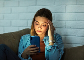 smartphone phone woman young female girl mobile headache pain migrane problem stress mobile phone night dark glowing light screen portrait cellphone using