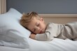 © Fortis Design - A happy kid, baby boy peacefully sleeps radiating innocence and joy. The soft smile on his tiny face reflects the love and tenderness surrounding him. Cozy sleeping. Peaceful dreams. Comfortable bed.