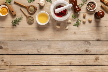 Poster - Healthy food cooking ingredients background with herbs, spices and olive oil on wooden table with copy space top view. Asian menu concept