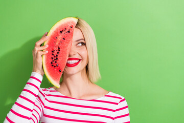 Sticker - Photo of gorgeous woman with bob hairstyle wear striped shirt hold watermelon on eye look empty space isolated on green color background