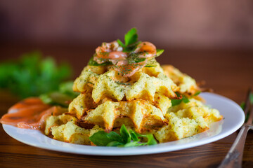 Wall Mural - Cooked potato waffles with lightly salted red fish and herbs in a plate.