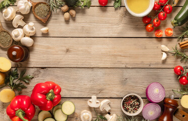 Poster - Frame of healthy food cooking ingredients background with fresh vegetables, herbs, spices and olive oil on wooden table with copy space