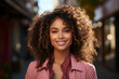 © Tjeerd - professional afro american business woman, happy confident positive female entrepreneur standing outdoor on sunny street arms crossed, looking at camera