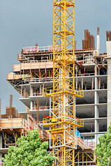 Wall Mural - Construction of concrete high rise residential building with the crane in front