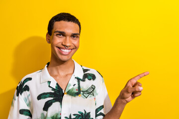 Wall Mural - Photo of cheerful satisfied guy in stylish clothes arm direct empty space seasonal proposition benefit isolated on yellow color background