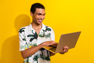 Sticker - Photo of clever pleasant man with nose piercing dressed palm print shirt look at laptop chatting isolated on yellow color background