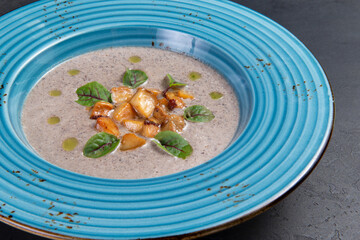 Cream of mushroom soup. On a dark background.