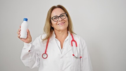 Canvas Print - Middle age hispanic woman doctor smiling confident holding medication bottle over isolated white background