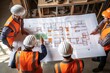 Team of young men engineer and architects working, meeting, discussing, designing, planing, measuring layout of building blueprints in construction site floor at factory.top view & copy space
