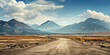 © kalafoto - An empty dirt road leading to the mountains