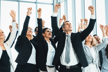 Wall Mural - Successful business people standing together showing strong relationship of worker community. A team of businessman and businesswoman expressing a strong group teamwork at the modern office. Jivy