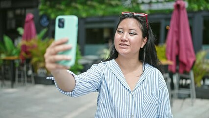 Sticker - Young chinese woman smiling confident having video call at coffee shop terrace