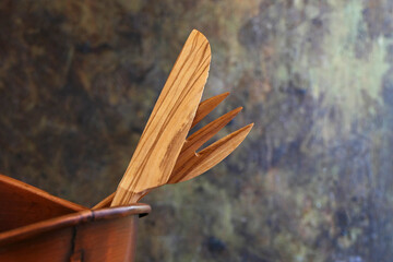 handmade wooden kitchen utensils in copper bowl