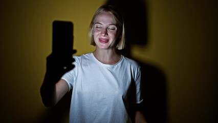 Poster - Young blonde woman smiling confident having video call over isolated yellow background