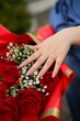 hands of the bride and flowers
