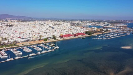 Canvas Print - Aerial drone footage of the Portuguese southern town of Olhao. View of the city and harbor, sailboats and municipal market