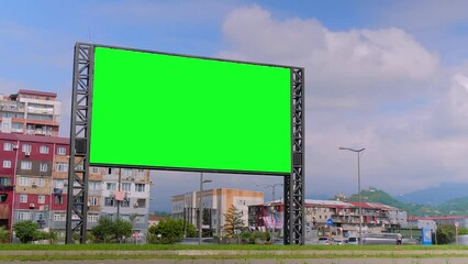 Wall Mural - timelapse: blank green billboard or large display against moving car traffic, white clouds in the bl