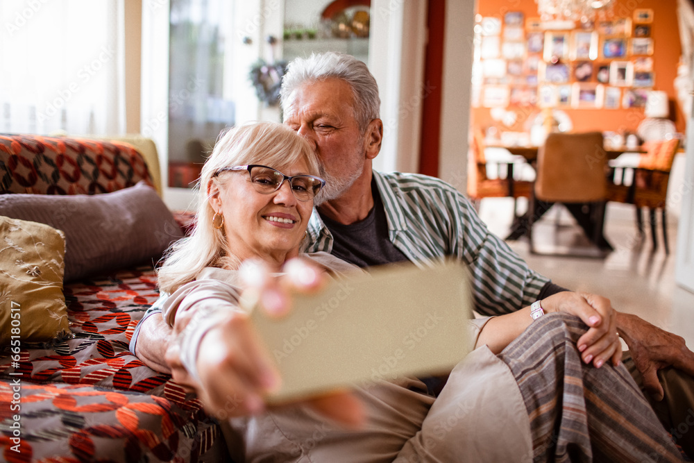 Loving elderly couple taking a selfie at home Stock Photo | Adobe Stock