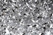 Shimmering silver confetti descending on clear background. Cheerful and glitzy tinsel. Generative AI