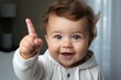 happy baby raising his index finger