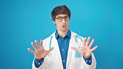 Poster - Young hispanic man doctor doing calm gesture over isolated blue background