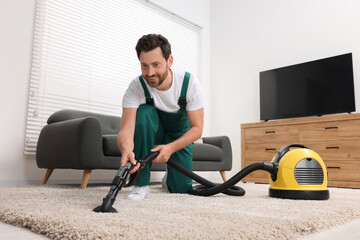 Wall Mural - Dry cleaner's employee hoovering carpet with vacuum cleaner in room