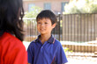 © Austockphoto - School boy listening to his friend in the playground