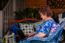 Grandmother using laptop to video call her grandchildren and stay connected