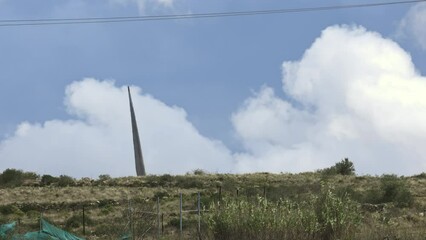 Wall Mural - Single wind turbine amidst open terrain.