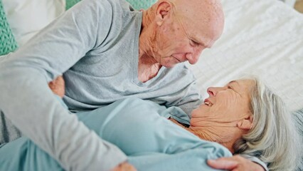 Wall Mural - Senior, love and happy couple kiss in bed, care and bonding together in home. Hug, elderly man and woman in bedroom for connection, support and healthy relationship, romance and relax in retirement