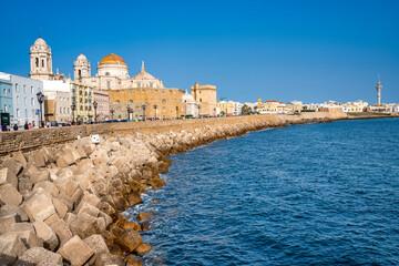 Sticker - Cadiz, Spain - April 8, 2023: Tourists on the city promenade along the ocean