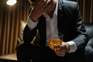 Businessman wearing a suit whiskey glass of liquor.