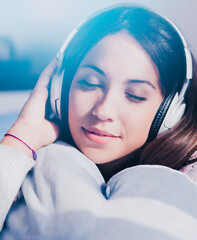 Wall Mural - Young Teenager Listening Music Lay in Bed Smiling With Closed Eyes And White Headphones, With Heart Shaped Pillow