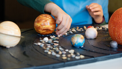 Wall Mural - child's hands designing solar system