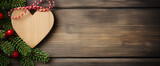 Fototapeta  - Festive wooden heart ornament on rustic background with pine branches and berries. Christmas and New Year concept. Design for holiday greeting card, banner with copy space for text