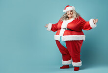 Plus Size Happy Plump Girl Attractive Overweight Model On Blue Background In Red Clothes In Christmas Style, Funny Clown Santa Claus