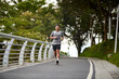 © imtmphoto - young asian man running jogging exercising outdoors in park