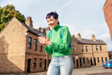 Portrait of a beautiful happy young woman  talking on her mobile and excited about good news regarding her job application