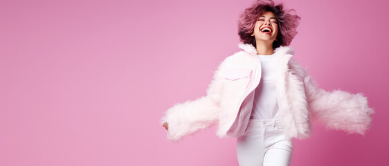 Young woman laughing dressed in fluffy fur coat isolated on flat color background with copy space. Faux fur coat eco banner template. 