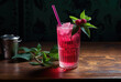 Indulge in a refreshing and vibrant drink with a twist of cranberry juice, served in a classic highball glass and adorned with a delicate straw and green garnish