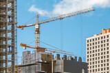 Fototapeta Las - Crane, concrete blocks and scaffolding