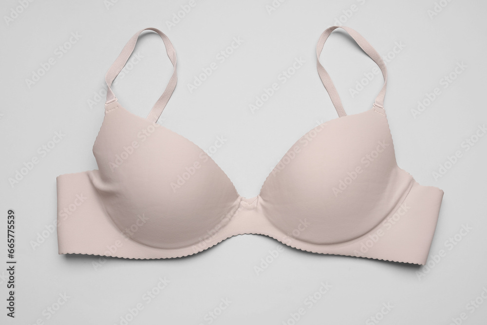 Stylish female bra on grey background