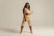 © gstockstudio - Happy curvy African woman in sportswear looking confident in her body