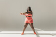 © gstockstudio - Full length of confident African plus size woman in sportswear doing stretching exercises