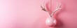 Christmas decoration with reindeer horns and pink ball on a pink background